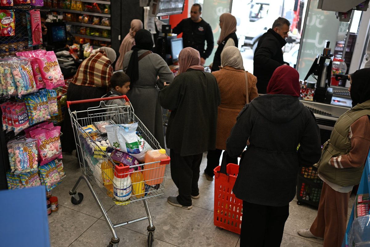 Families with full carts at the checkout