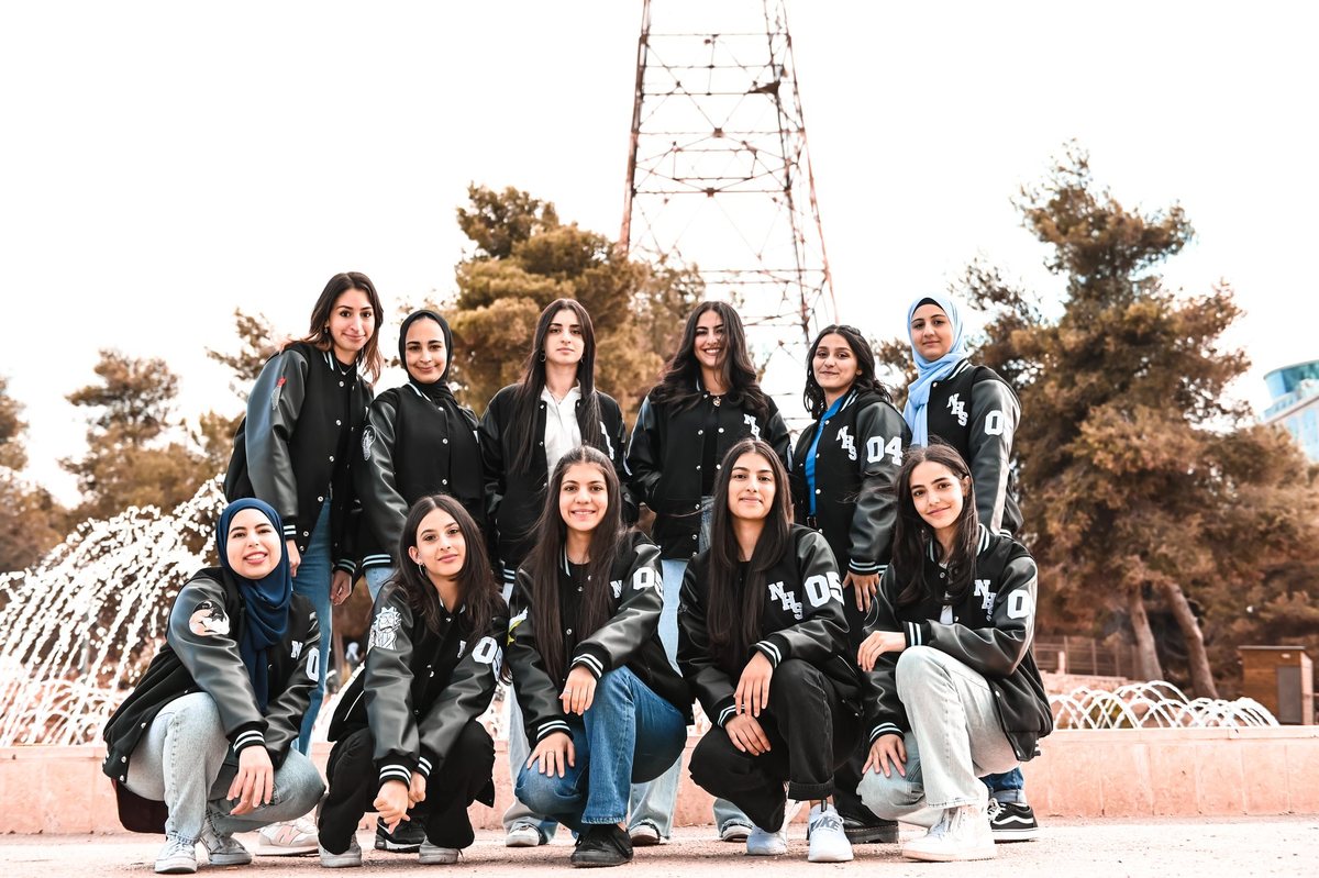 Students in varsity jackets, group shot