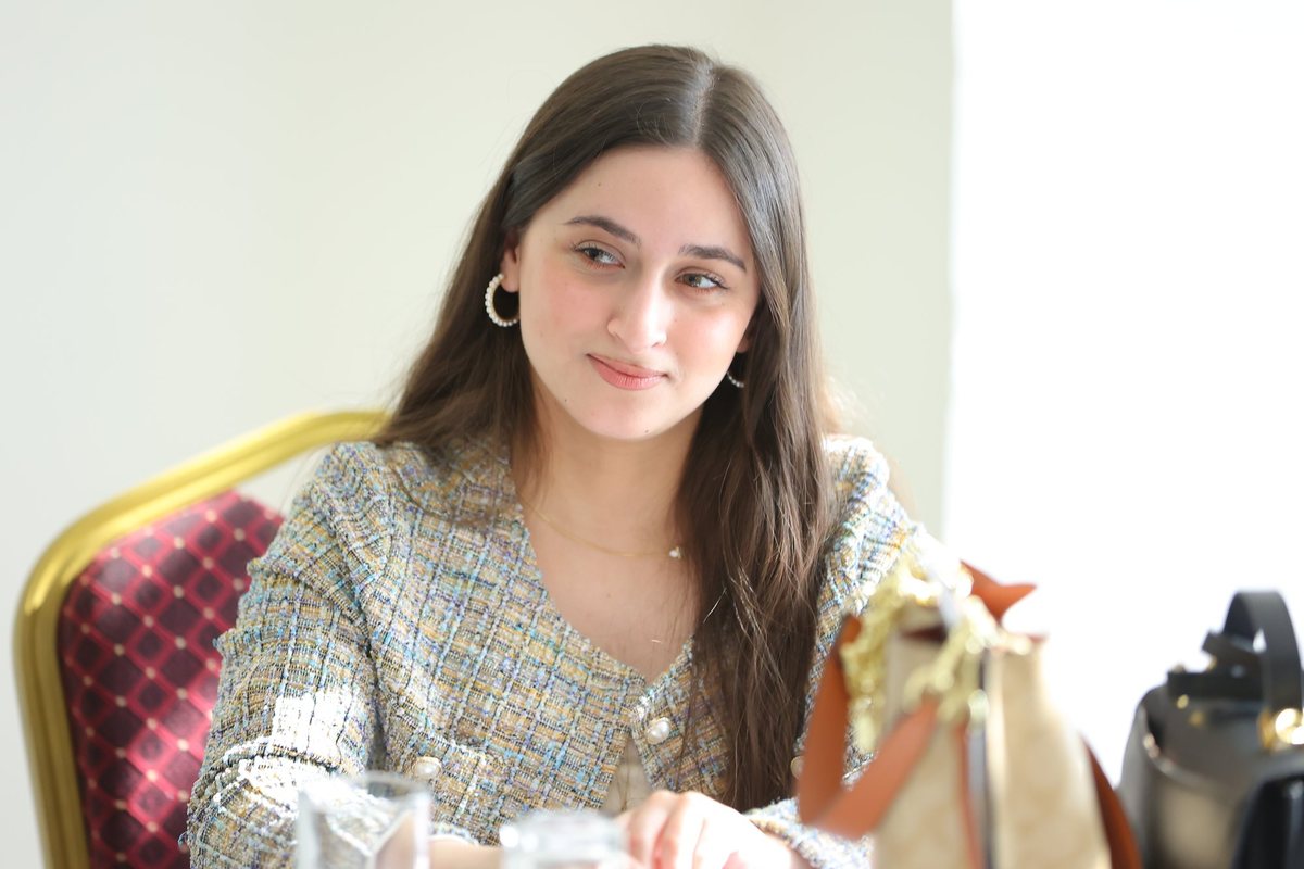 A participant smiling at her table