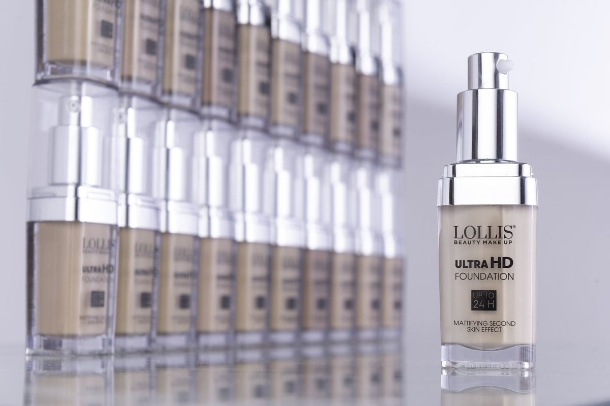 A LOLLIS Ultra HD foundation bottle in front of a row