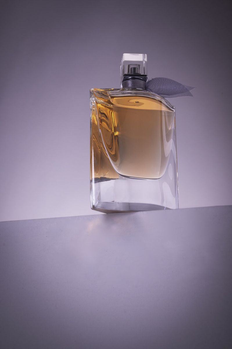 A perfume bottle on lilac