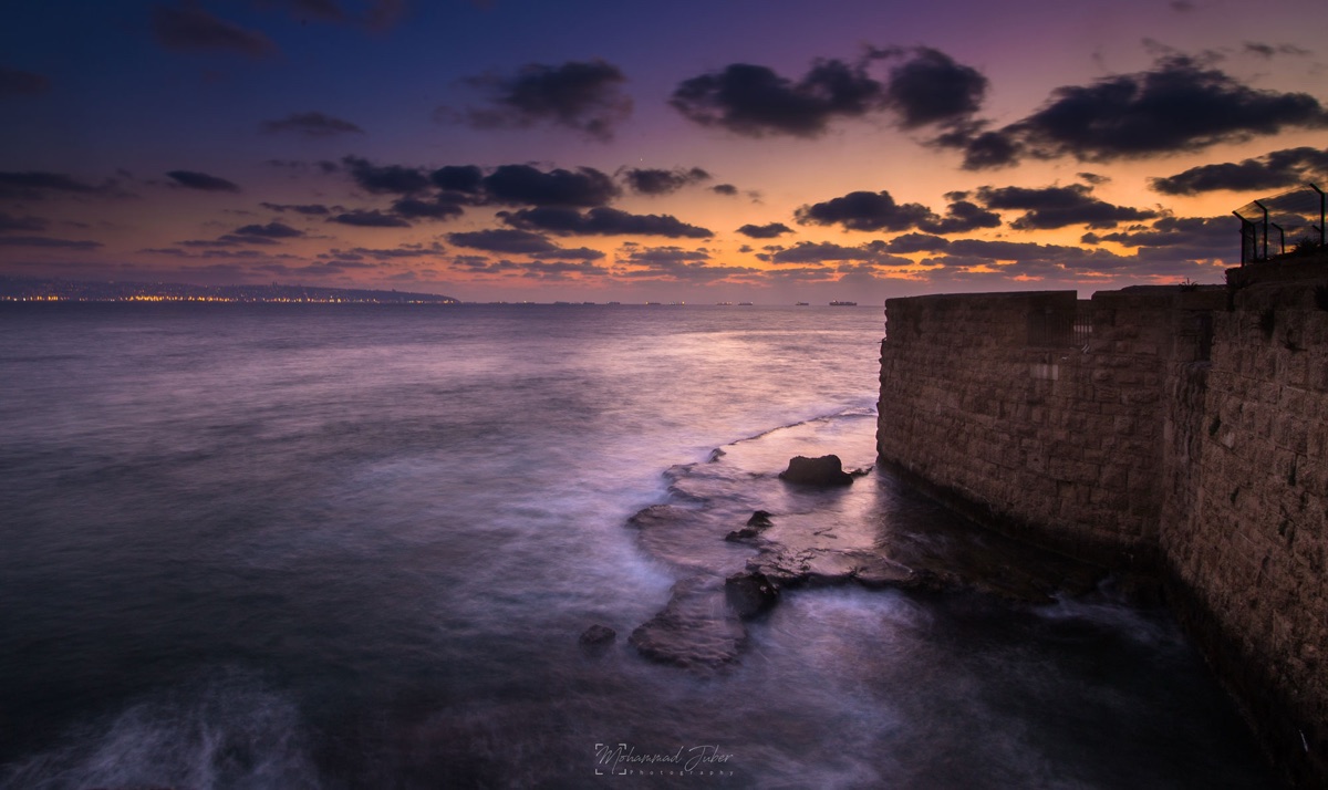 An old stone sea wall at sunset, long exposure