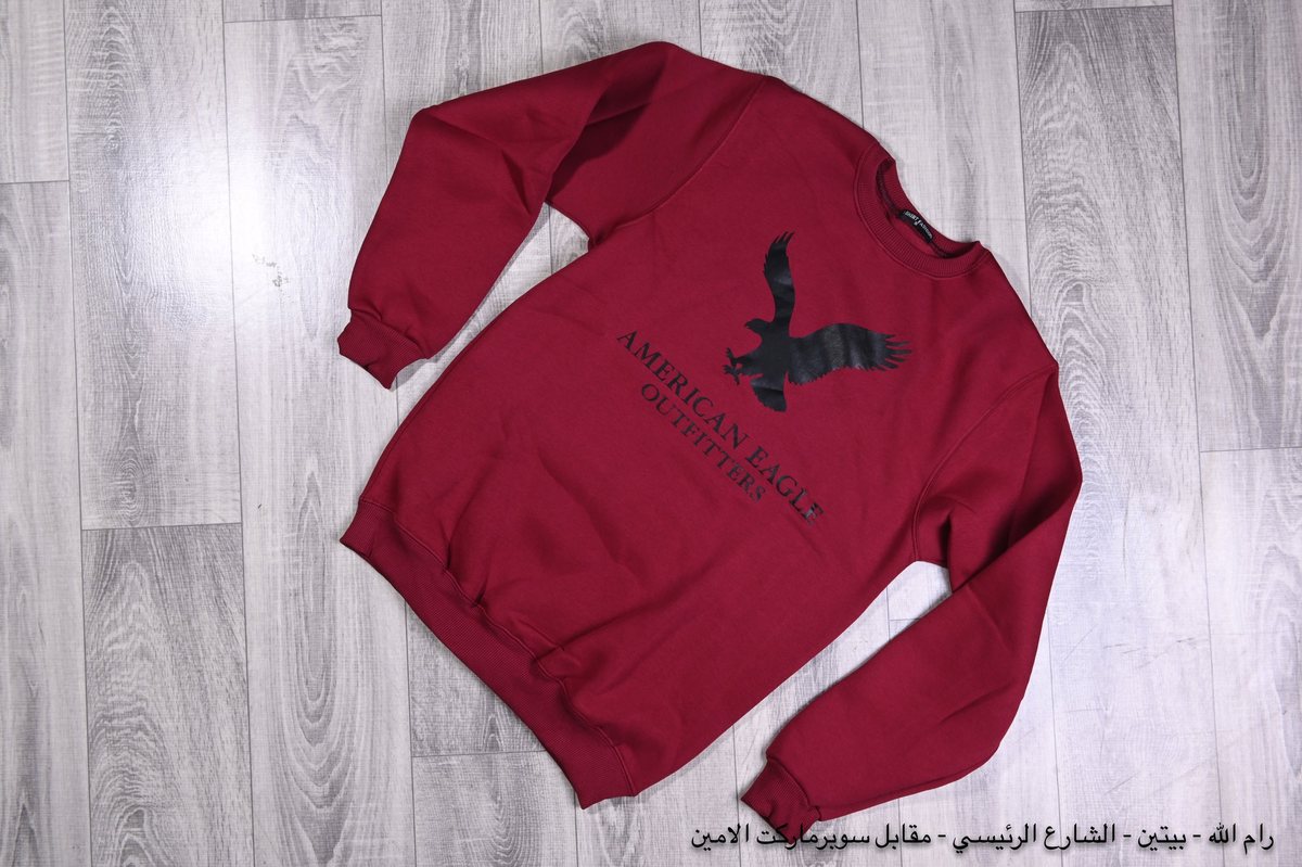 A burgundy sweatshirt laid flat