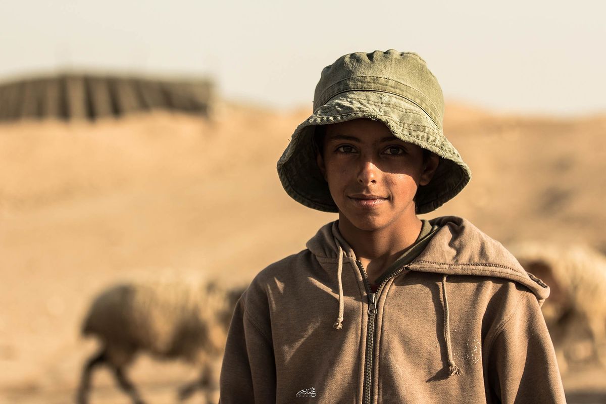 A shepherd boy in a bucket hat