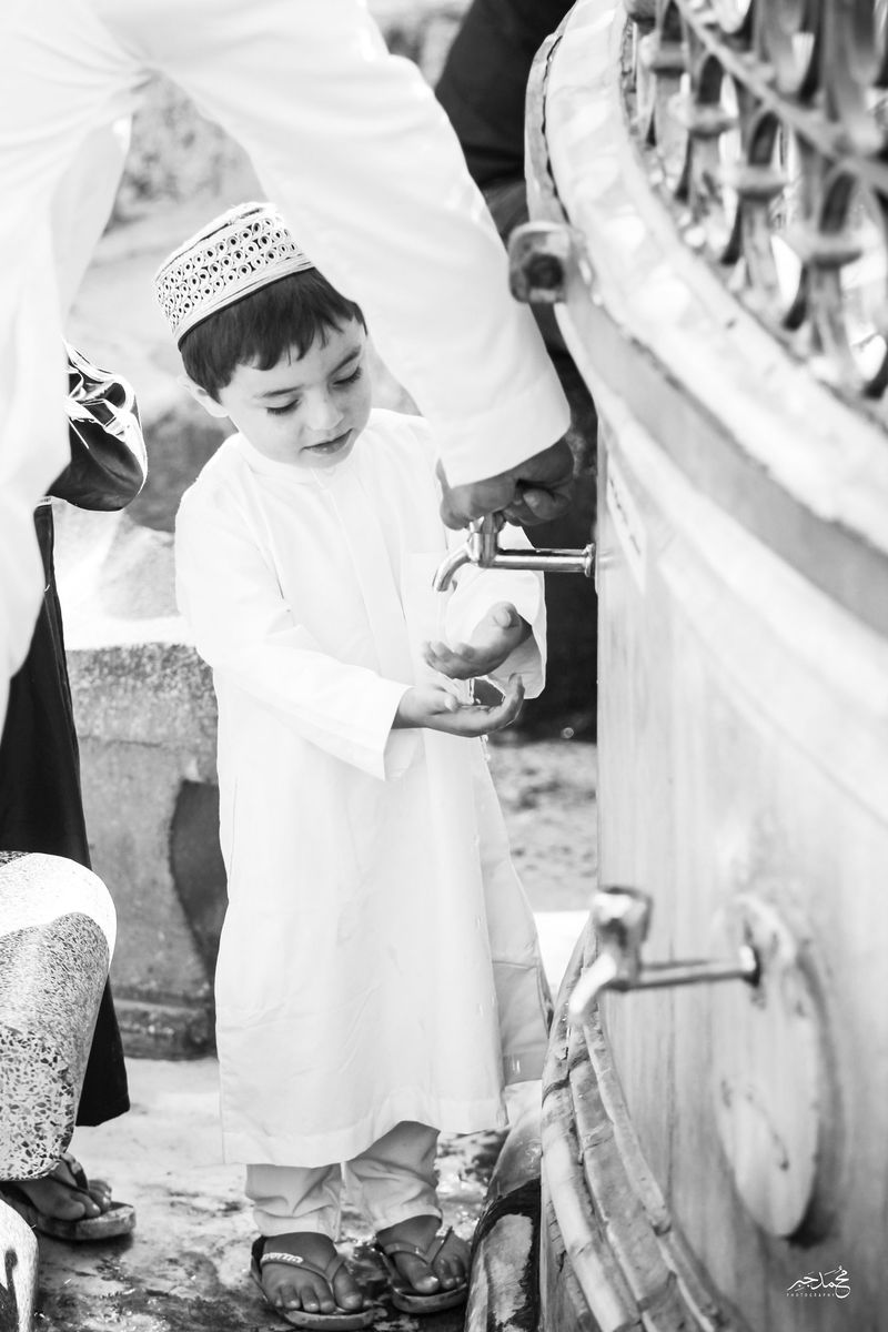 A boy at a fountain, black and white