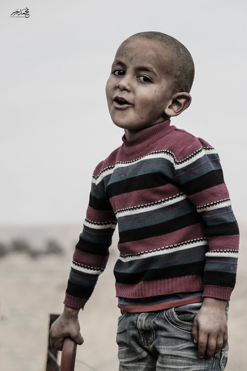 A boy in a striped sweater