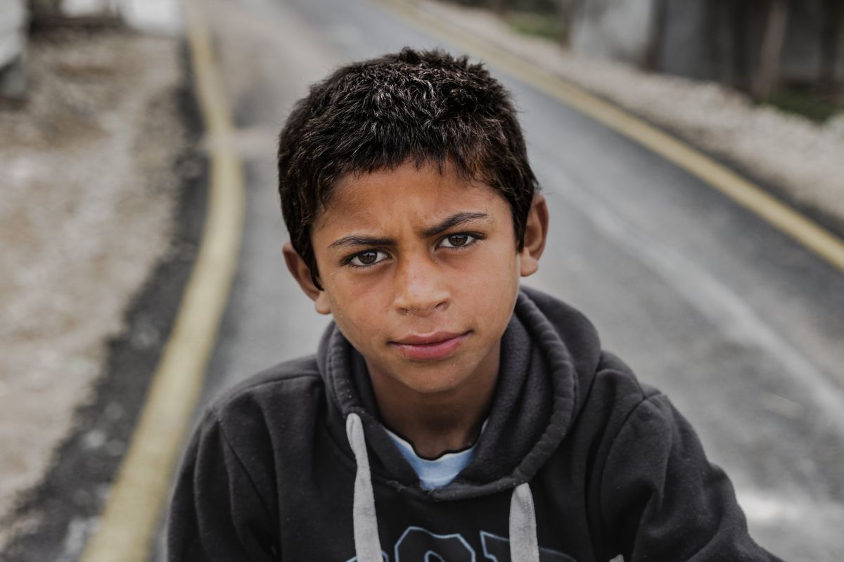 A boy in a hoodie on a road