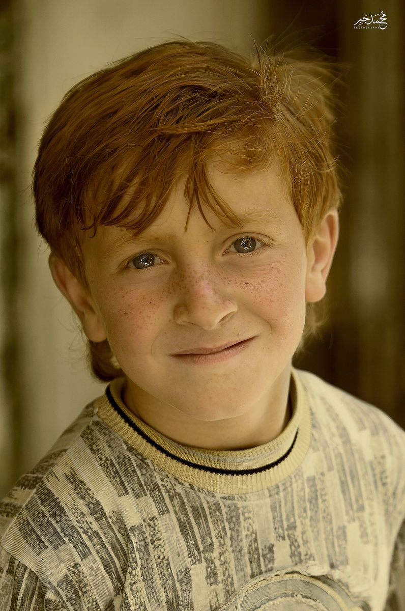 A red-haired boy smiling