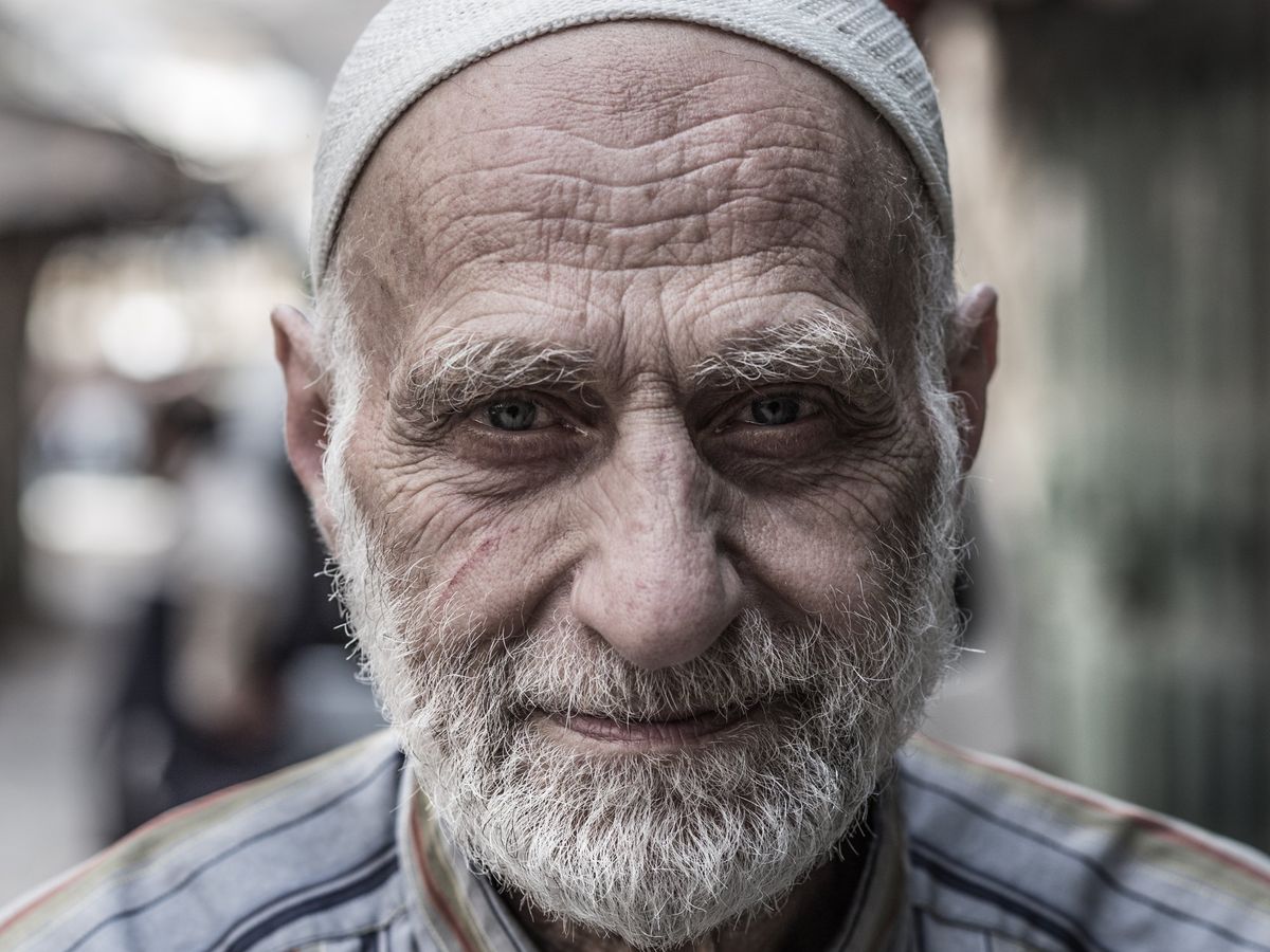 An old man in a white cap