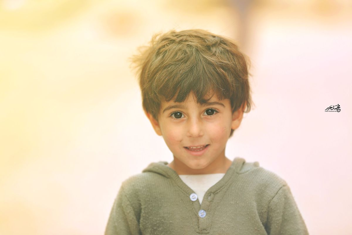A smiling boy in warm light