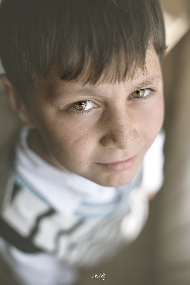 A boy with a white scarf