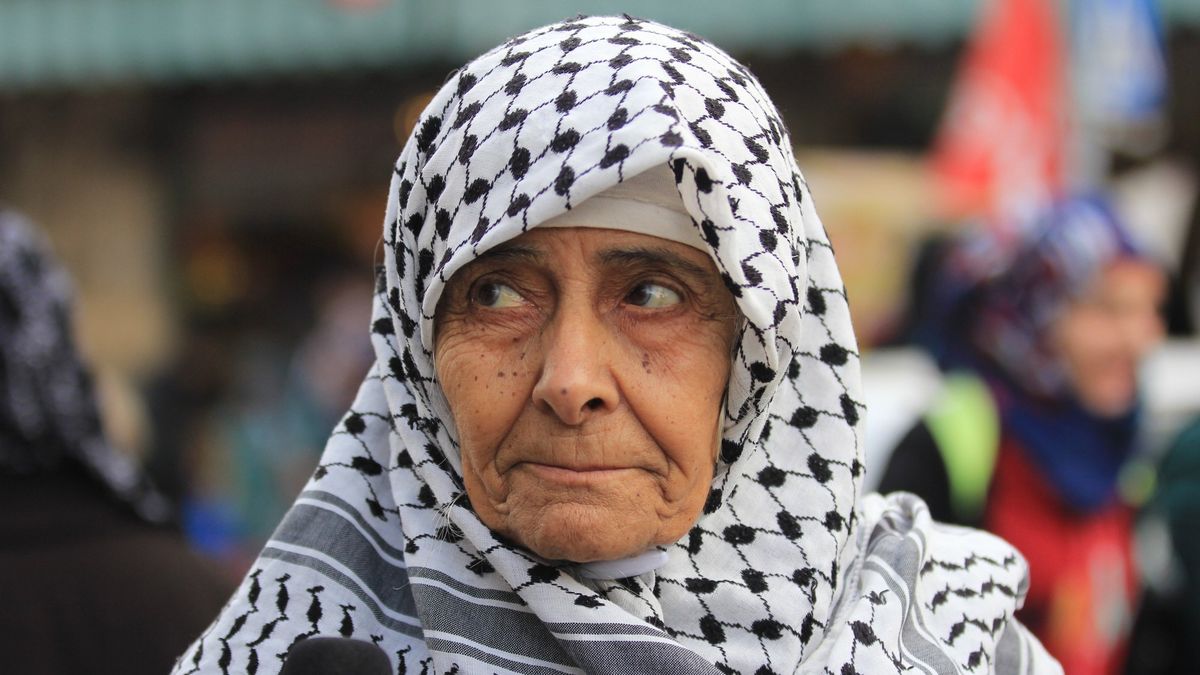 An old woman in a keffiyeh