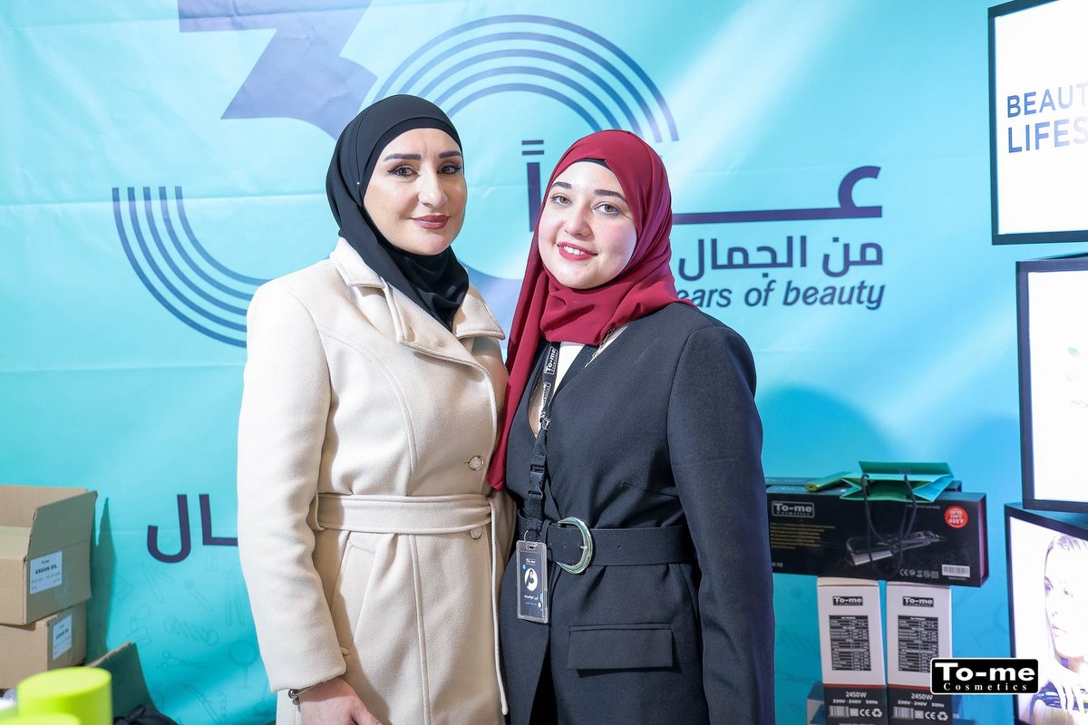 Two staff members at the booth