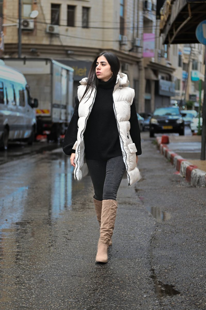 A white puffer vest on a rainy street