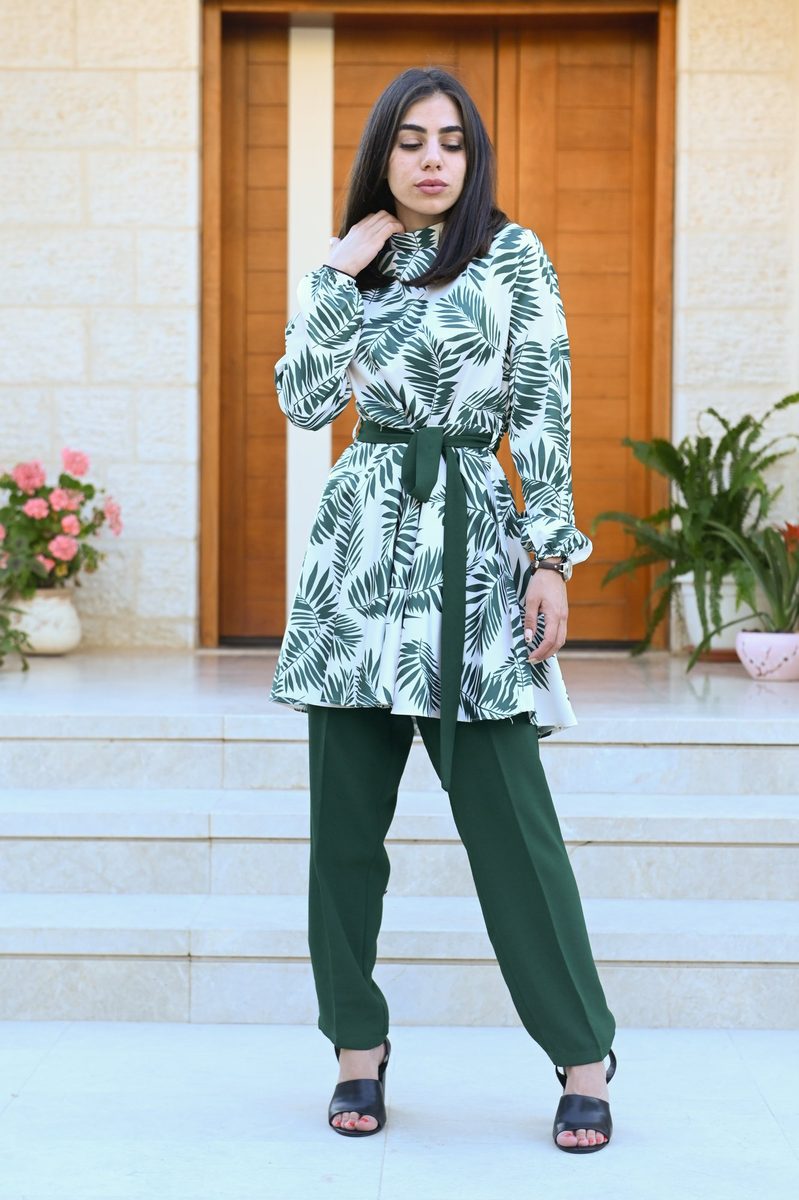 A green paisley jacket and trousers at a doorway
