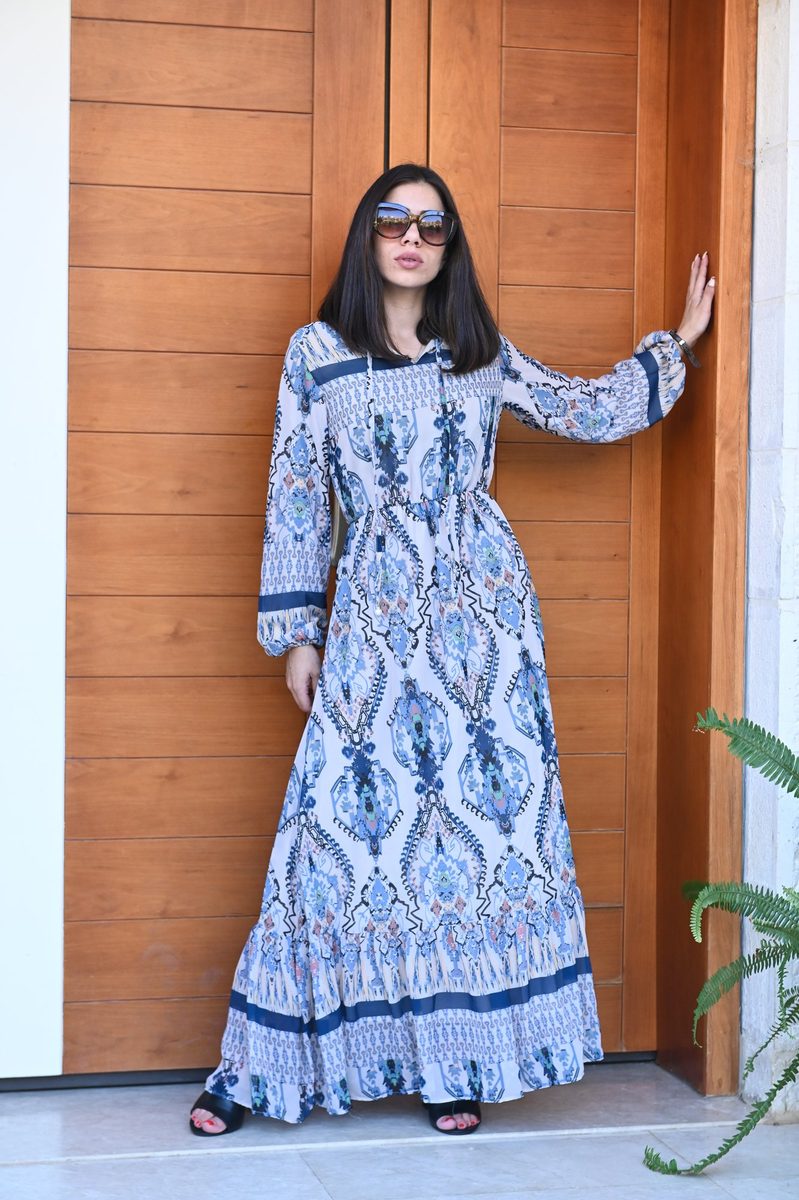 A blue paisley maxi dress at a wooden door