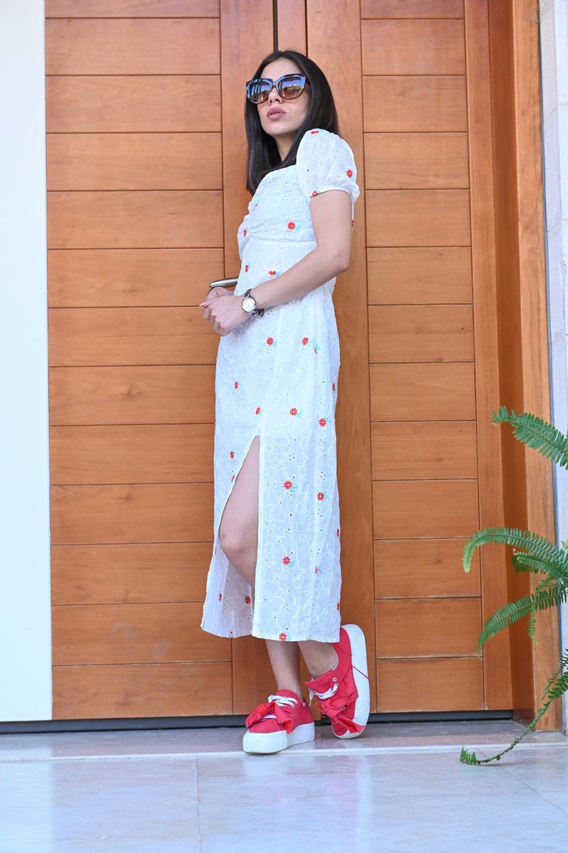 A white floral dress and red sneakers