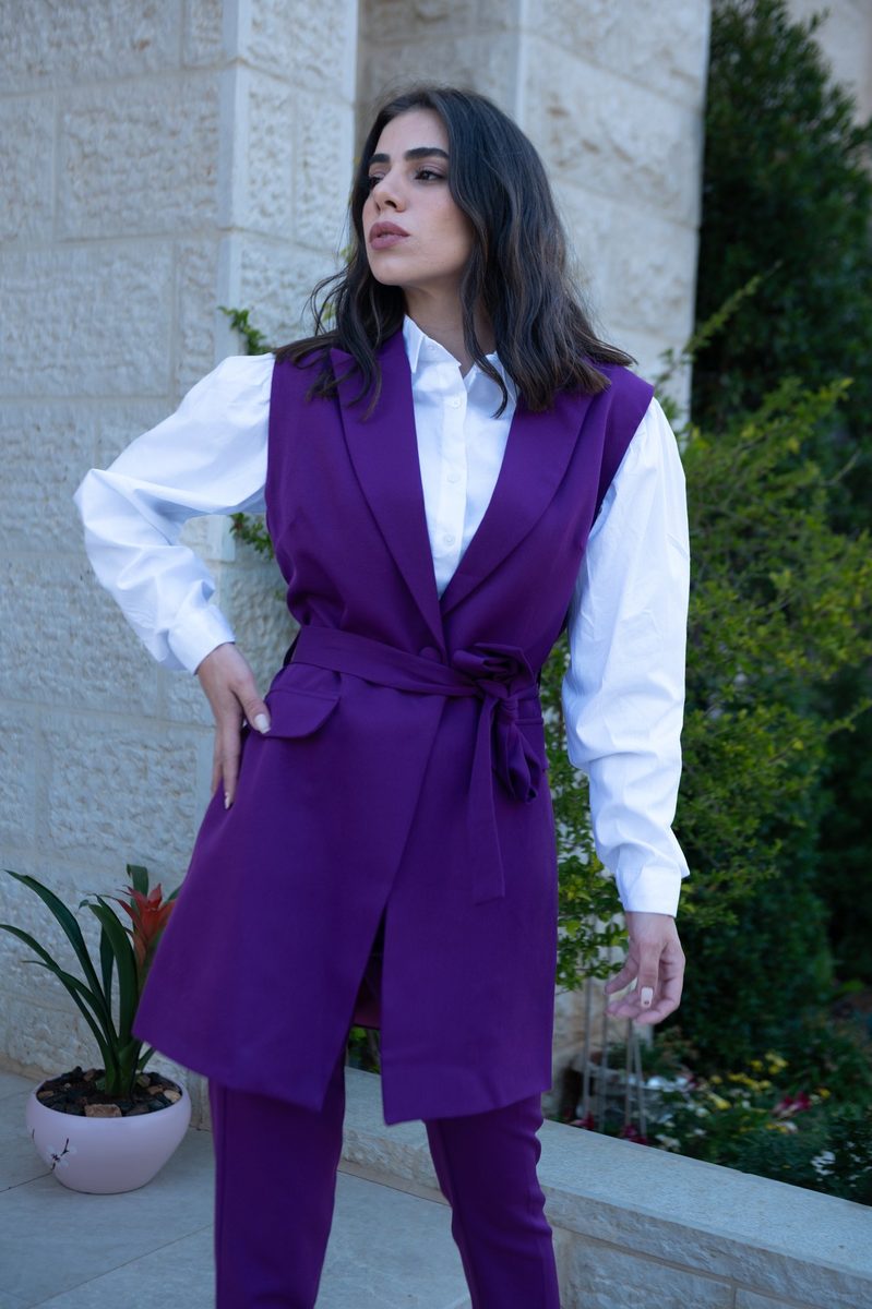 A long purple vest over a white shirt